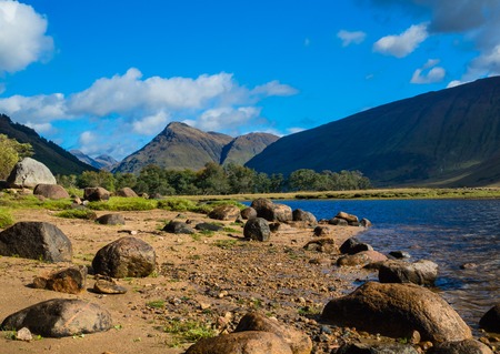 Wide view of Loch Etive in the Glencoe Valley surrounded by the Grampian Mountains, Scotlandの写真素材