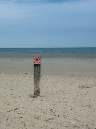 Wooden beach pole along the Dutch coast of Amelandの写真素材