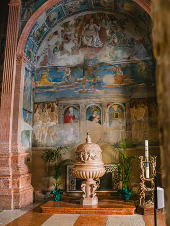 Baptismal font and frescoes in one of the chapels of the Metropolitan cathedral in Modena, Italyのeditorial素材