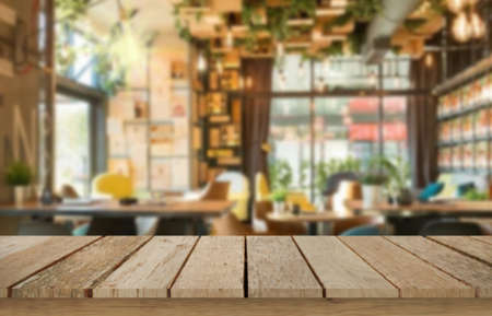 Wooden table top on blur restaurant or cafe background.For montage product display or design key visual layout.View of copy space.の写真素材