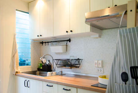 Faucet and sink on top of wooden table for washing dish or other utensil.Interior decorate kitchen.In contemporary style.View of copy space.の写真素材