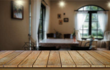 Wooden table top on blur restaurant or cafe background.For montage product display or design key...