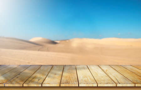 Wooden table top on blur desert background.Hot weather and drink somethings for fresh.Juice and cold water.For montage product display or design key visual layout.View of copy space.の写真素材
