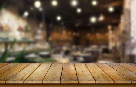 Wooden table top on blur restaurant background.For montage product display or design key visual layout.View of copy space.の写真素材