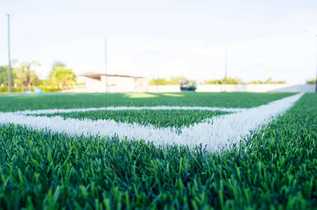 Green grass field for soccer or football competition.Decorate sports game stadium background.Popular foot sport.Fans stadium side of field.の写真素材