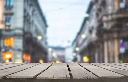Wooden table top on blur urban city landscape town background.For montage product display or design key visual layout.View of copy space.の写真素材