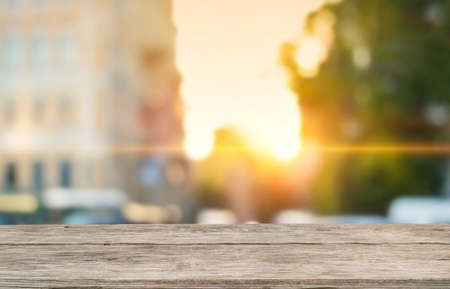 Wooden table top on blur Urban city landscape background.For montage product display or design key visual layout.View of copy space.の写真素材