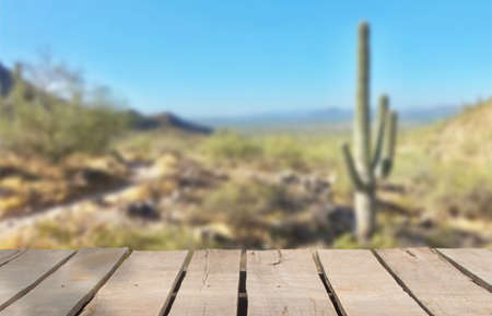 Wooden table top on blur cactus desert background.Hot weather and drink somethings for fresh.Juice...