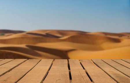 Wooden table top on blur desert background.Hot weather and drink somethings for fresh.Juice and cold water.For montage product display or design key visual layout.View of copy space.の写真素材