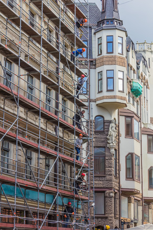 RIGA, LATVIA - JUNE 26, 2014. Reconstruction of building in the Old Town on 26 June 2014.  Old Town is the most popular touristic place in Riga.のeditorial素材