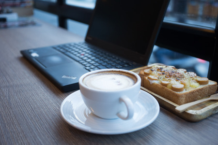 Cappuccino, latte blended with honey and put it on toast in coffee shop.の写真素材