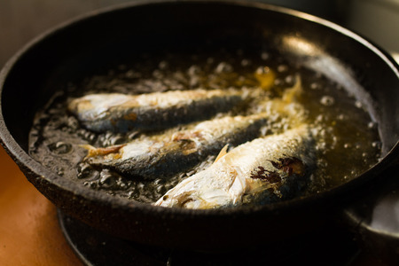 Fish from the sea in the Gulf Thailand pan fried in hot oil.の写真素材