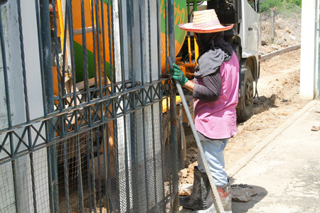 Pouring cement in the alley made by thai lebor.の写真素材