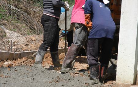 Pouring cement in the alley made by thai lebor.の写真素材