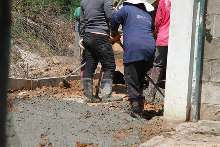 Pouring cement in the alley made by thai lebor.の写真素材