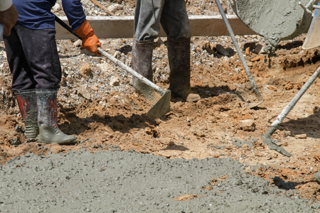 Pouring cement in the alley made by thai lebor.の写真素材