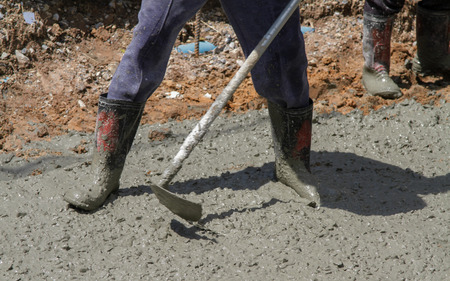 Pouring cement in the alley made by thai lebor.の写真素材