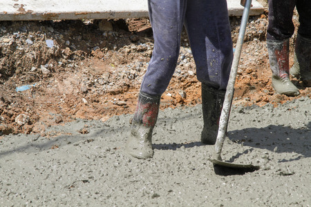 Pouring cement in the alley made by thai lebor.の写真素材