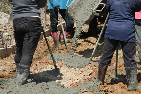 Pouring cement in the alley made by thai lebor.の写真素材