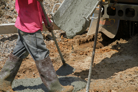 Pouring cement in the alley made by thai lebor.の写真素材