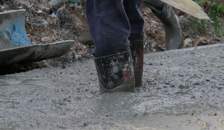Pouring cement in the alley made by thai lebor.の写真素材