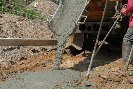 Pouring cement in the alley made by thai lebor.の写真素材