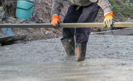 Pouring cement in the alley made by thai lebor.の写真素材