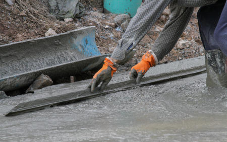 Pouring cement in the alley made by thai lebor.の写真素材