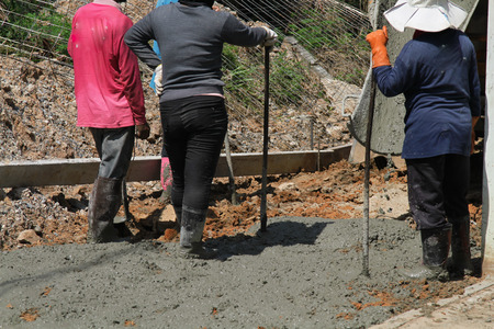 Pouring cement in the alley made by thai lebor.の写真素材