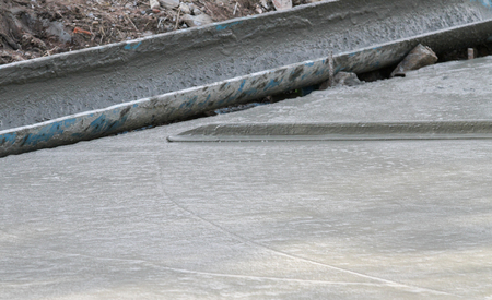 Pouring cement in the alley made by thai lebor.の写真素材