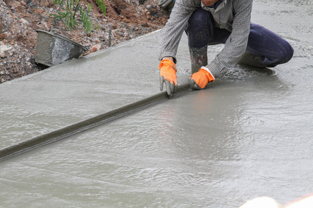 Pouring cement in the alley made by thai lebor.の写真素材