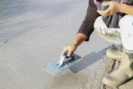 Pouring cement in the alley made by thai lebor.の写真素材