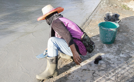 Pouring cement in the alley made by thai lebor.の写真素材