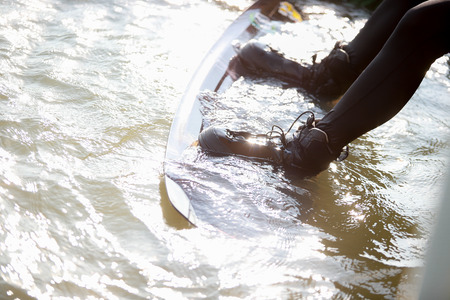 A man surfing in the water at a sports arena.