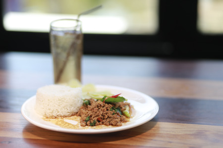 fried rice with basil on the table.の写真素材