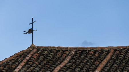old weather vane on the roof of a churchの写真素材