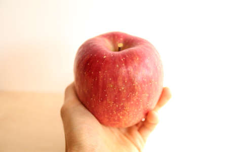 Red apple in my handの写真素材