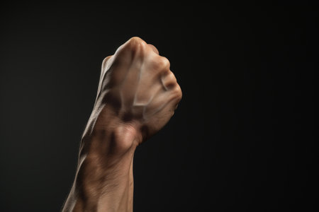 Hand holding fist, a symbol of determination. A high quality image making by generative ai.の素材