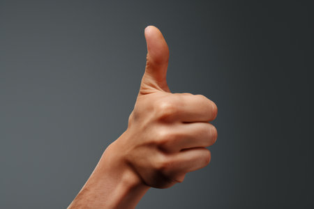Hand giving a thumbs up in approval. A high quality image making by generative ai.の素材