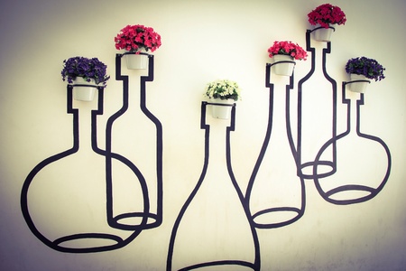 Colorful flower pots hang onto the wall.の素材