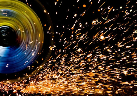 Sparks scatter the metal when cutting