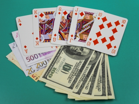 cards to rest upon money on green broadclothのeditorial素材