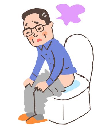 Sick man sitting on toilet seatの写真素材