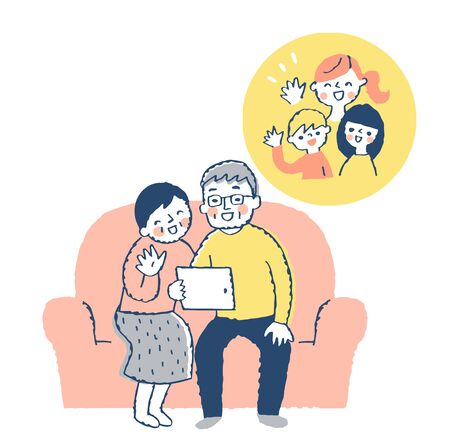 Senior couple making online calls with a smileの写真素材
