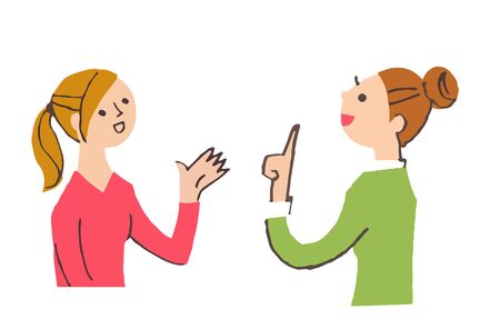 Two young women talkingの写真素材