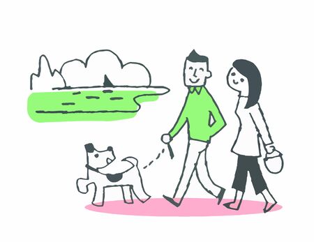 Couple walking with their dogs along the beachの写真素材