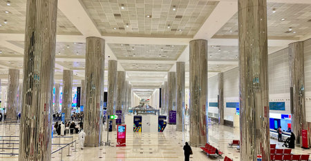 DUBAI,UNITED ARAB EMIRATES.15 SEPTEMBER 2023.Elevated view of dynamic Dubai Airport with bustling travelers and structural columnsのeditorial素材