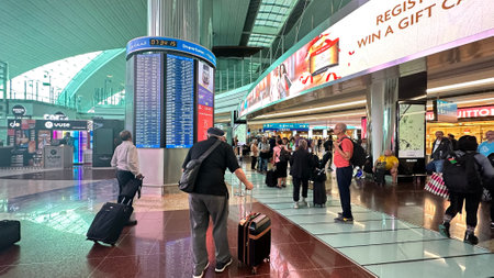 DUBAI, UAE. 16 SEPTEMBER 2023. Travelers stroll past Dubai Airport's duty-free shops, capturing airport leisure shoppingのeditorial素材