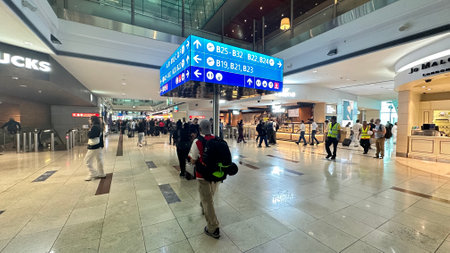 DUBAI, UAE. 16 SEPTEMBER 2023. Travelers navigate Dubai Airport's departure route, signboards aiding seamless transitのeditorial素材