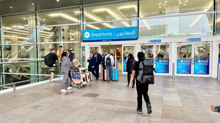 DUBAI, UAE. 16 SEPTEMBER 2023. A diverse group at Dubai airport entrance, symbolizing global travel and connectionのeditorial素材